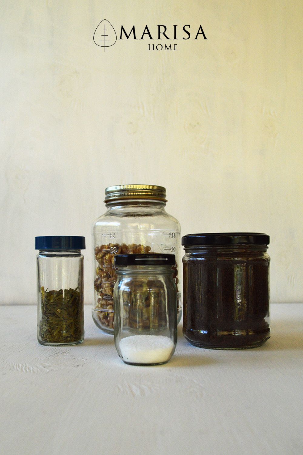 Reusable produce bags and glass storage jars arranged on a kitchen counter