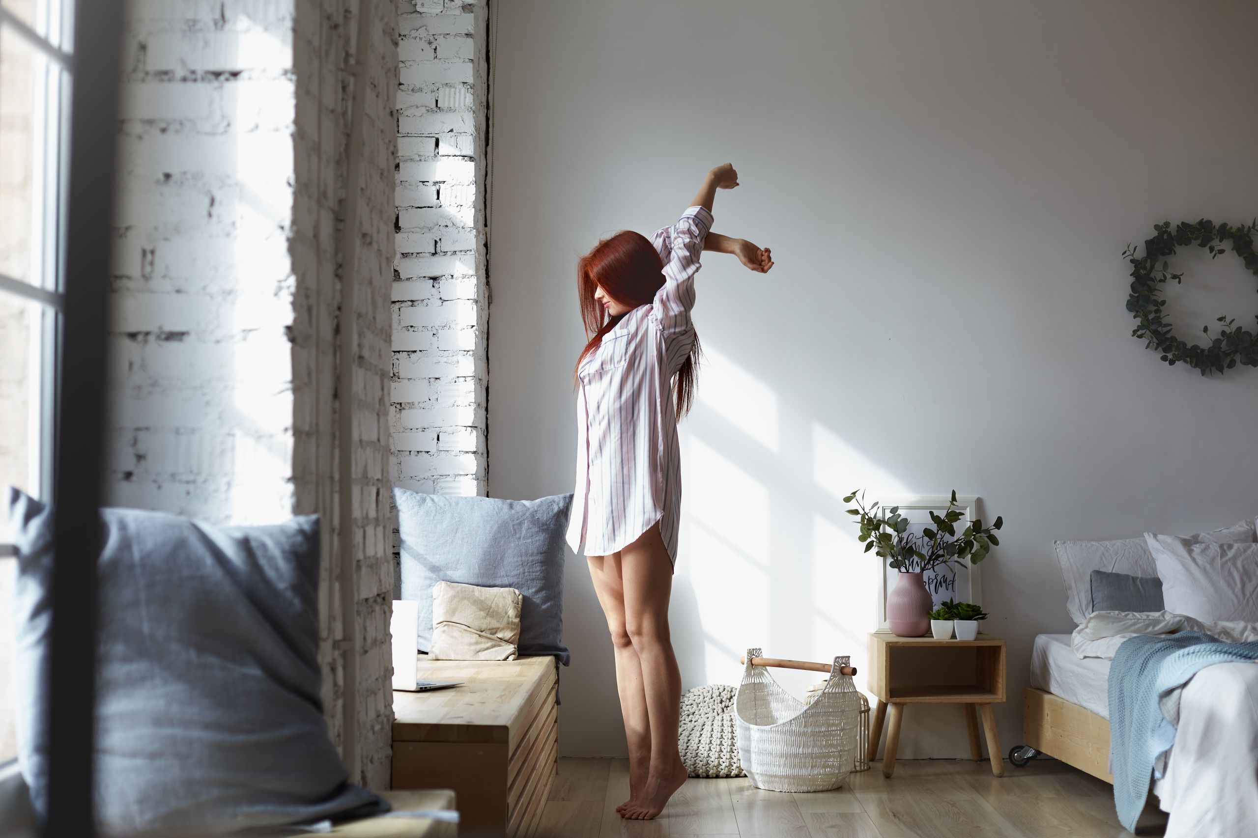 Morning sunlight streaming through bedroom window for better sleep and mood